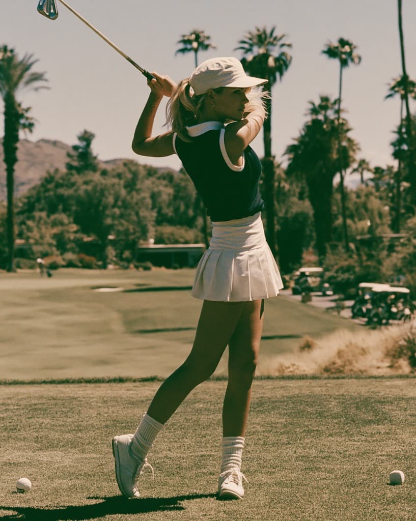 Golfer mid-swing on the fairway